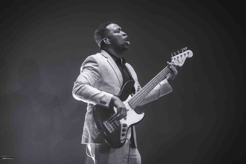 A bassist performing during Sunday worship at Realms of Glory